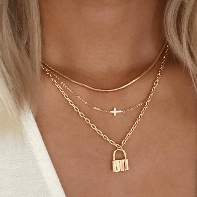 18K Gold Dipped Layered Necklace featuring a plain chain, horizontal cross and a lock charm