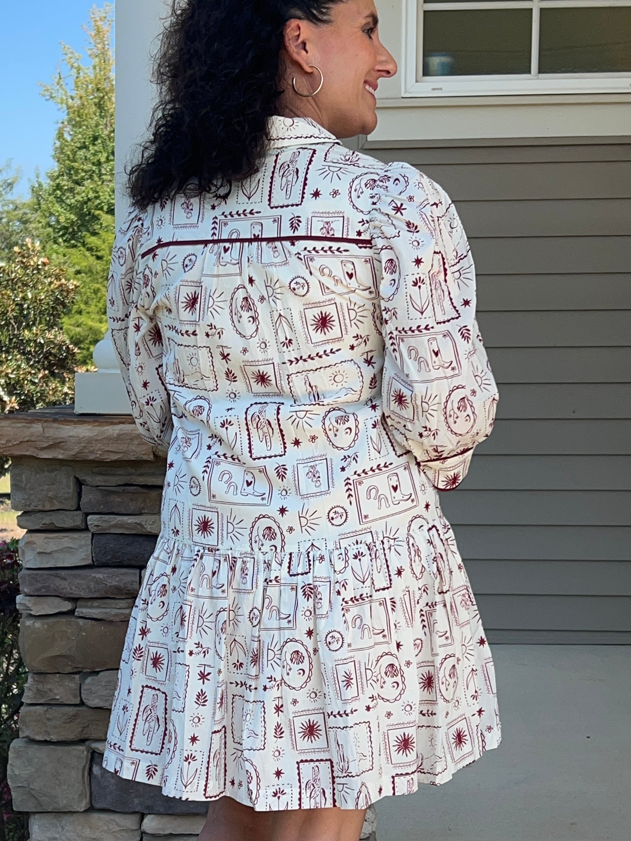 white v-neck dress with garnet colored western designs
