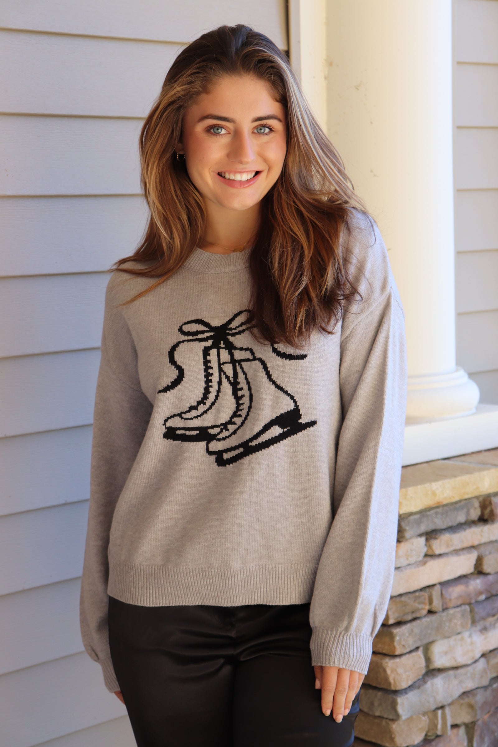 Gray sweater with black ice skate design