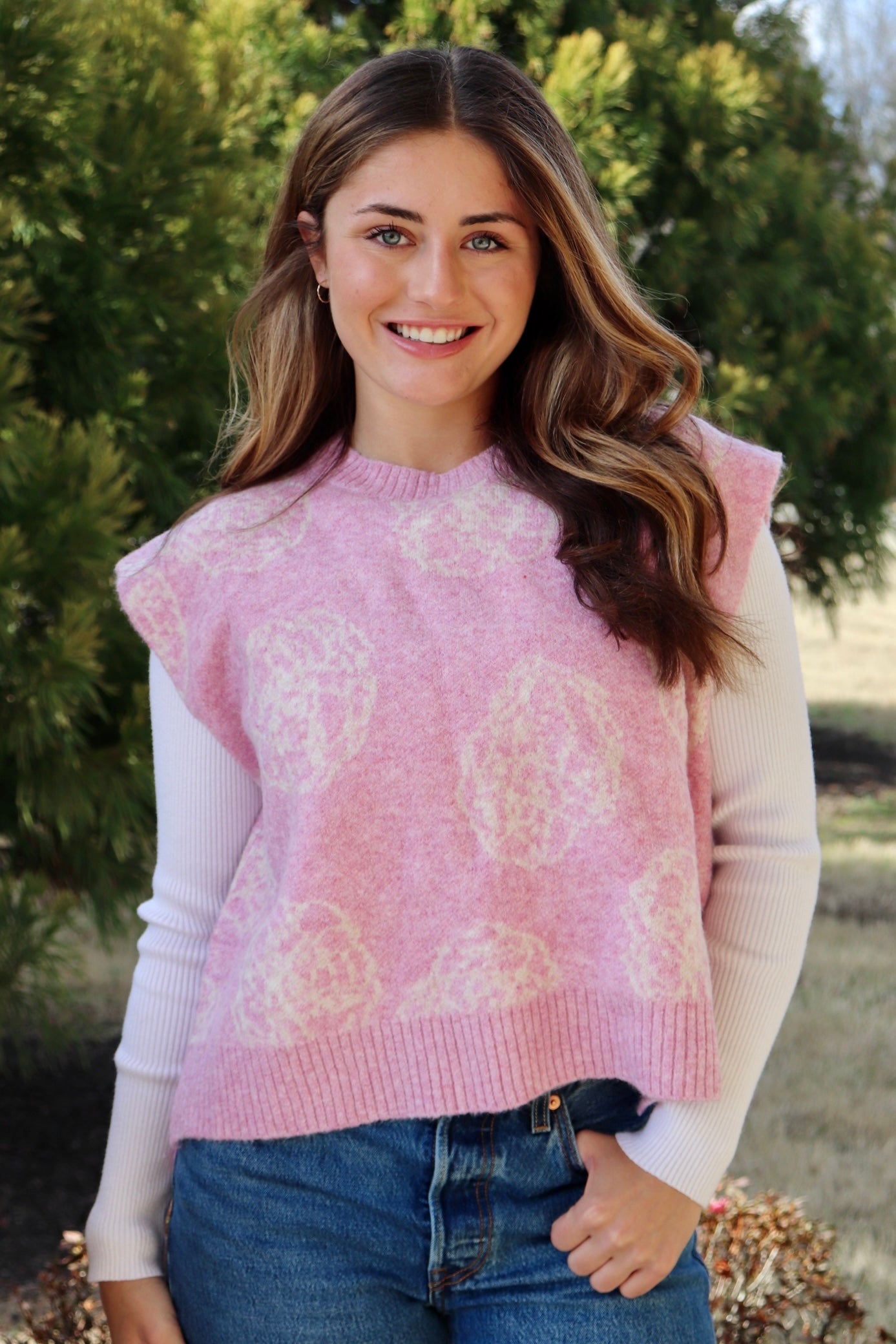 Pink short sleeve sweater vest with while floral print design