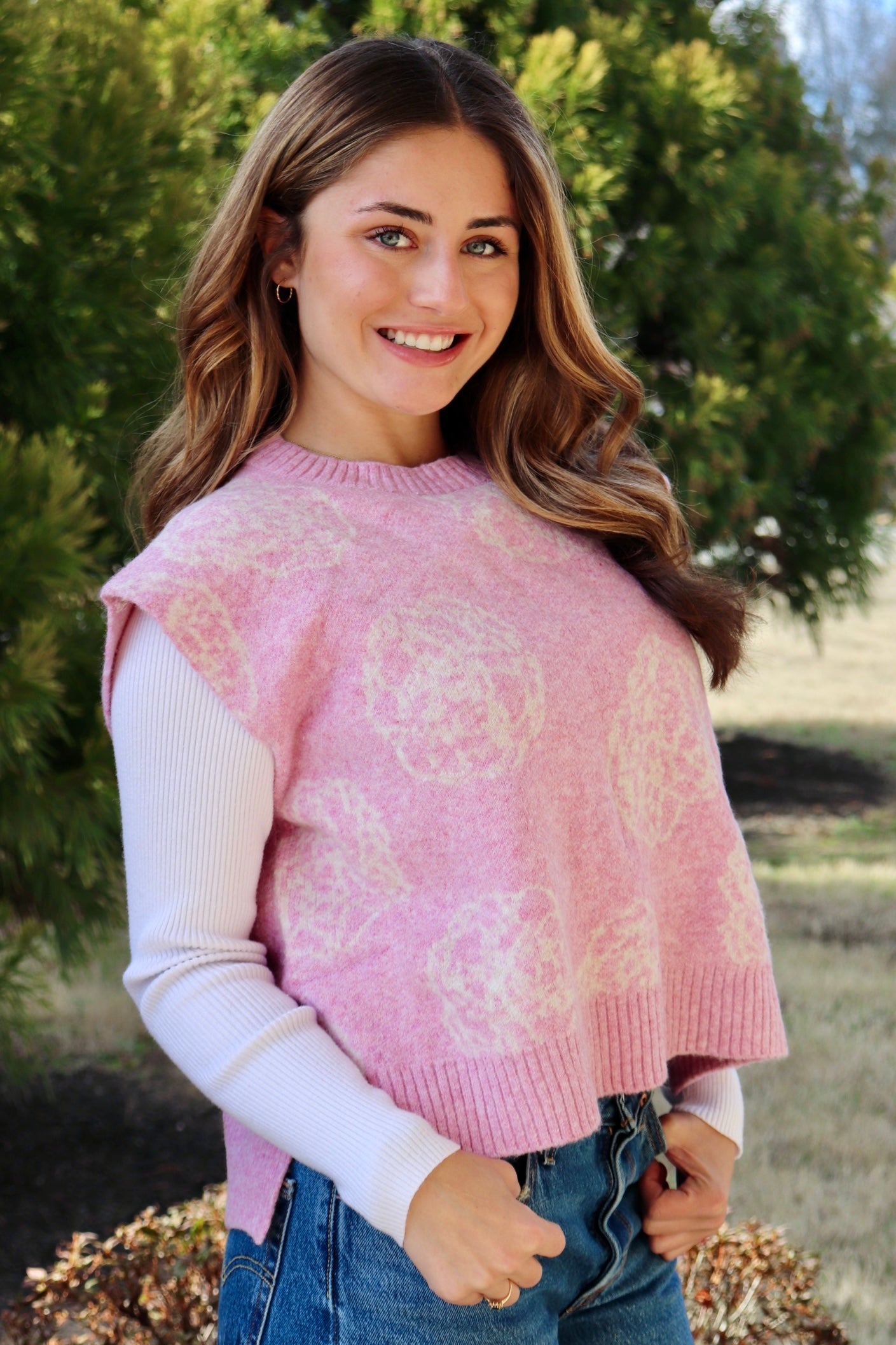 Pink short sleeve sweater vest with while floral print design