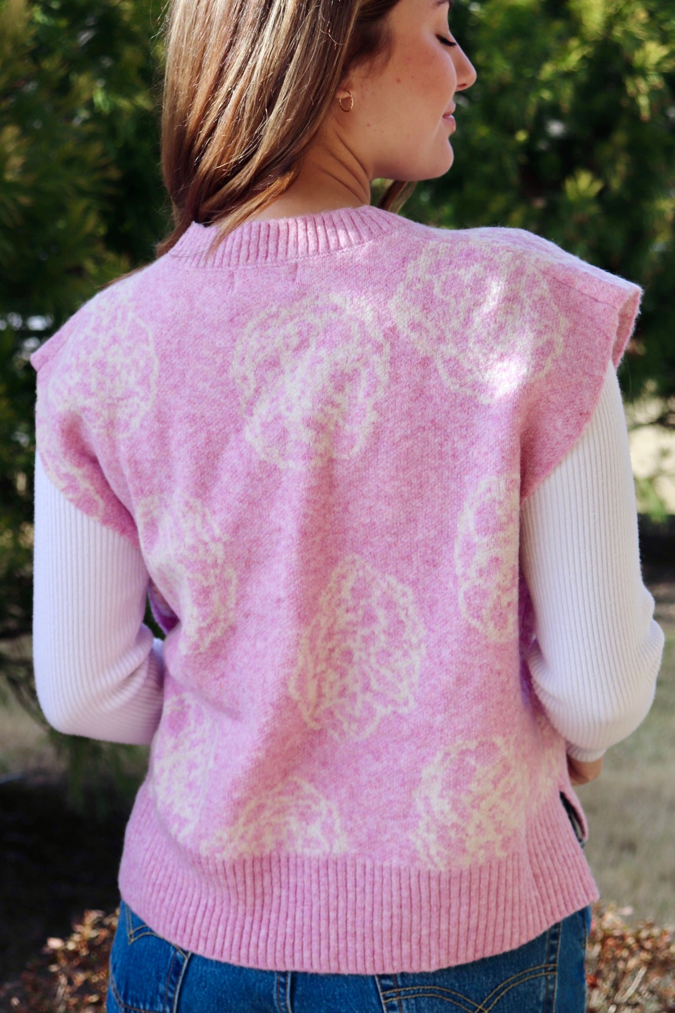 Pink short sleeve sweater vest with while floral print design