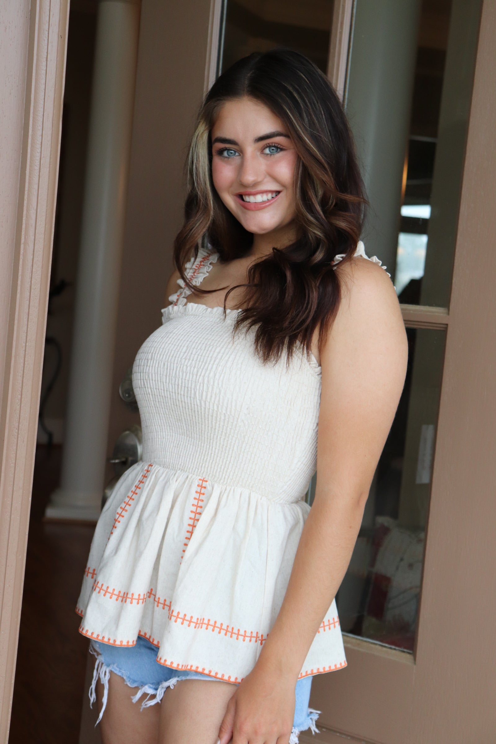 smocked linen peplum top with orange stitching