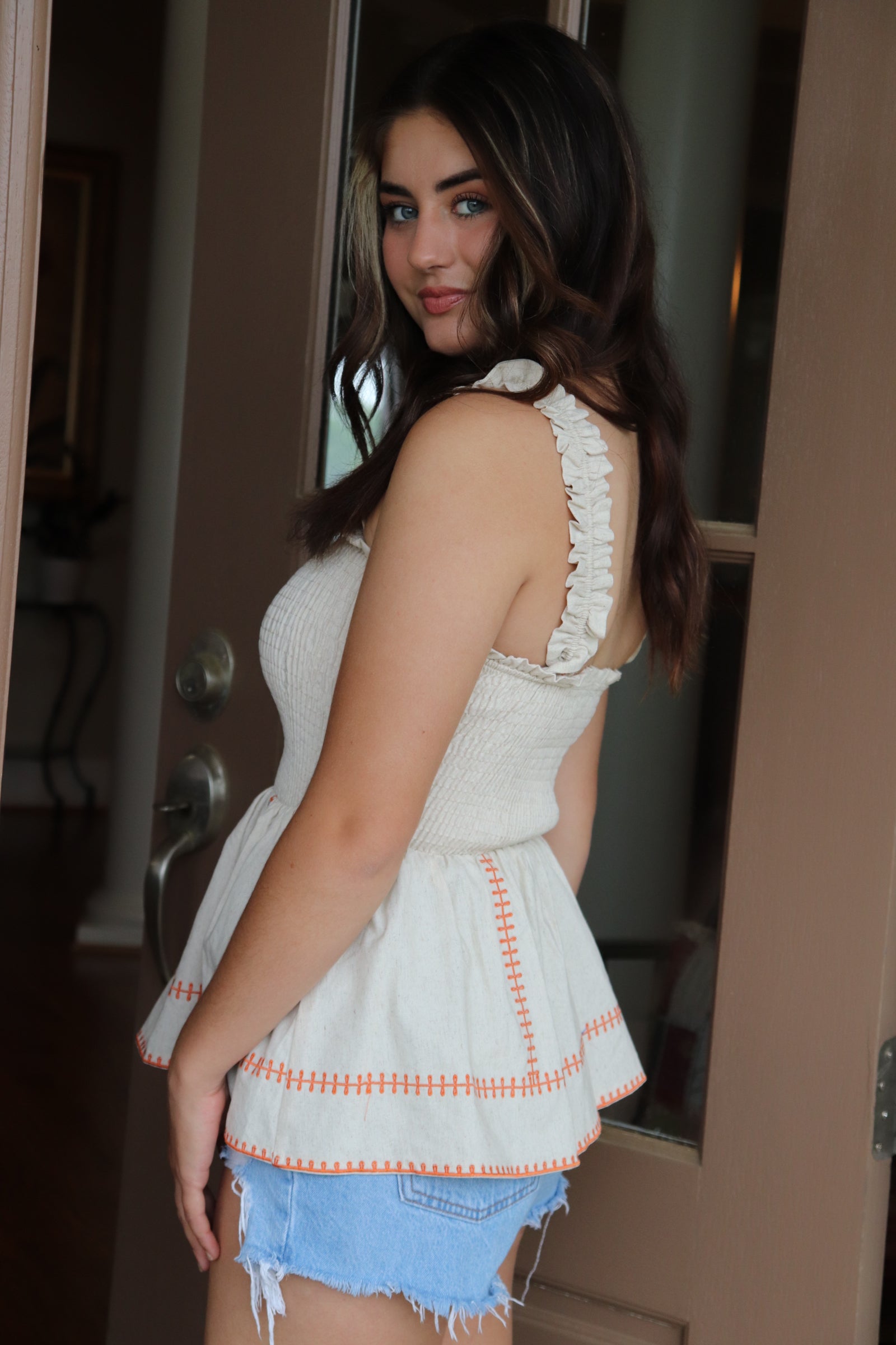 smocked linen peplum top with orange stitching