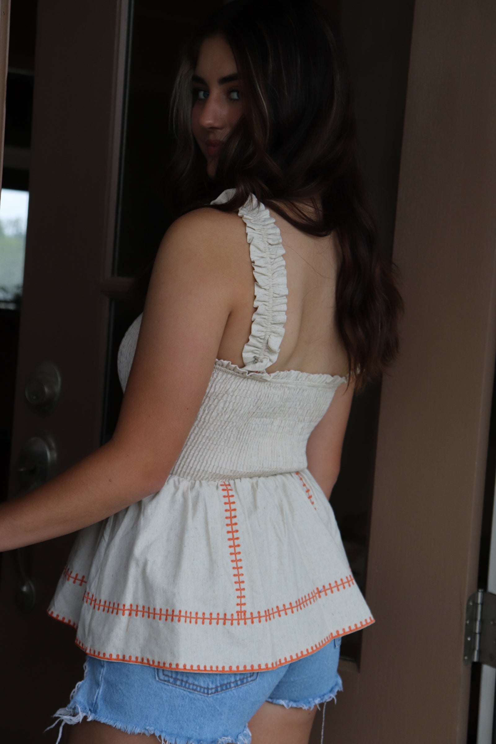 smocked linen peplum top with orange stitching