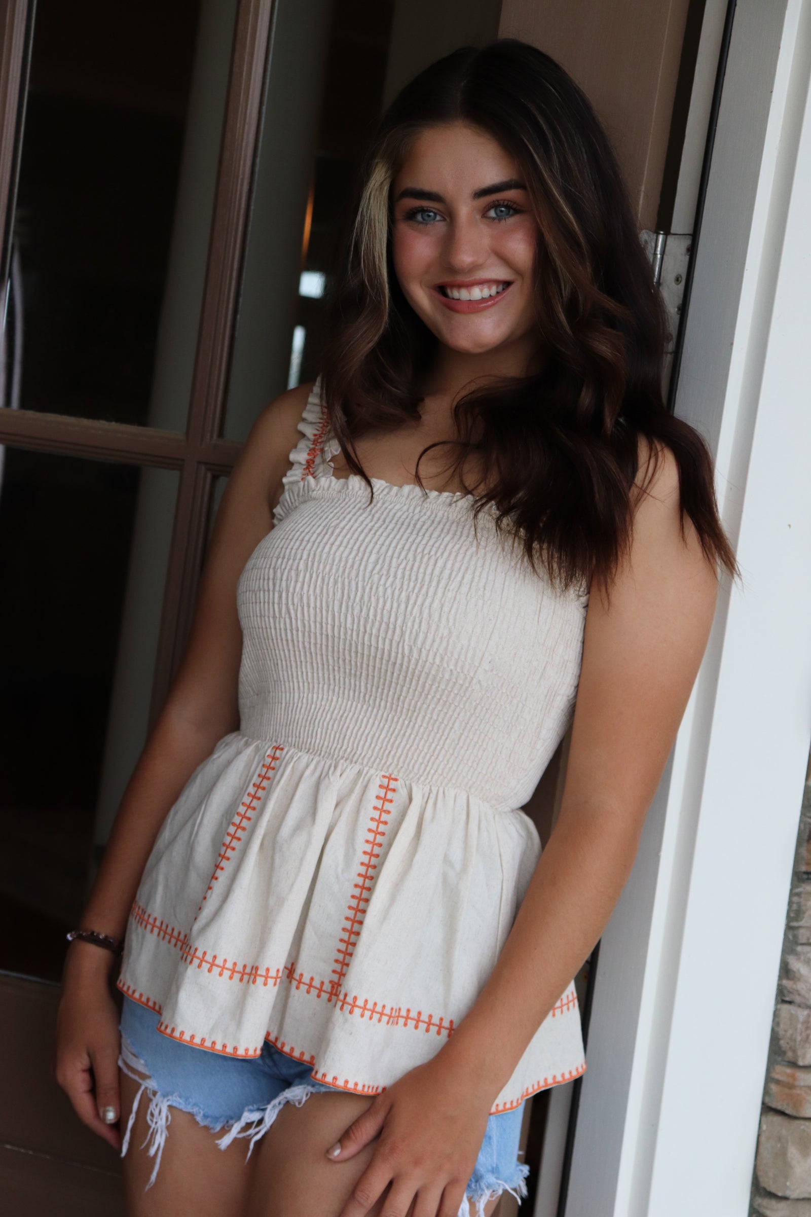 smocked linen peplum top with orange stitching