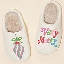 White slippers with colorful Very Merry wording and colorful ornament design.