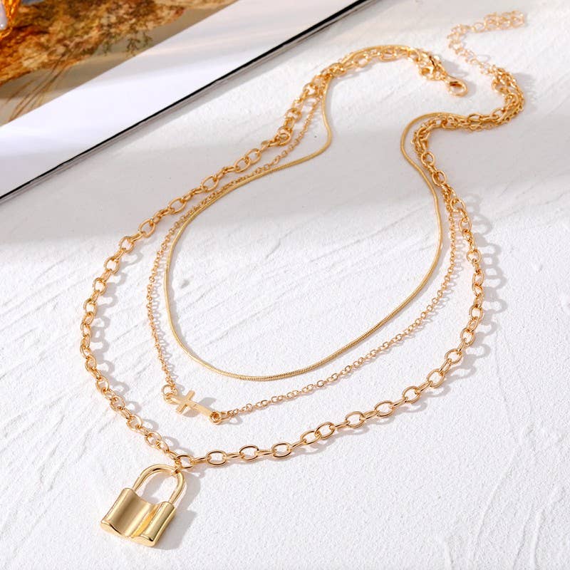 18K Gold Dipped Layered Necklace featuring a plain chain, horizontal cross and a lock charm