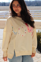 Load image into Gallery viewer, Cream colored sweatshirt with multi-colored LOVE quilted patchwork
