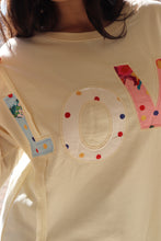 Load image into Gallery viewer, Cream colored sweatshirt with multi-colored LOVE quilted patchwork
