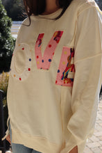 Load image into Gallery viewer, Cream colored sweatshirt with multi-colored LOVE quilted patchwork
