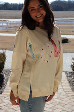 Load image into Gallery viewer, Cream colored sweatshirt with multi-colored LOVE quilted patchwork
