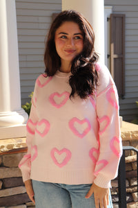 Light pink sweater with bright pink puffy hearts