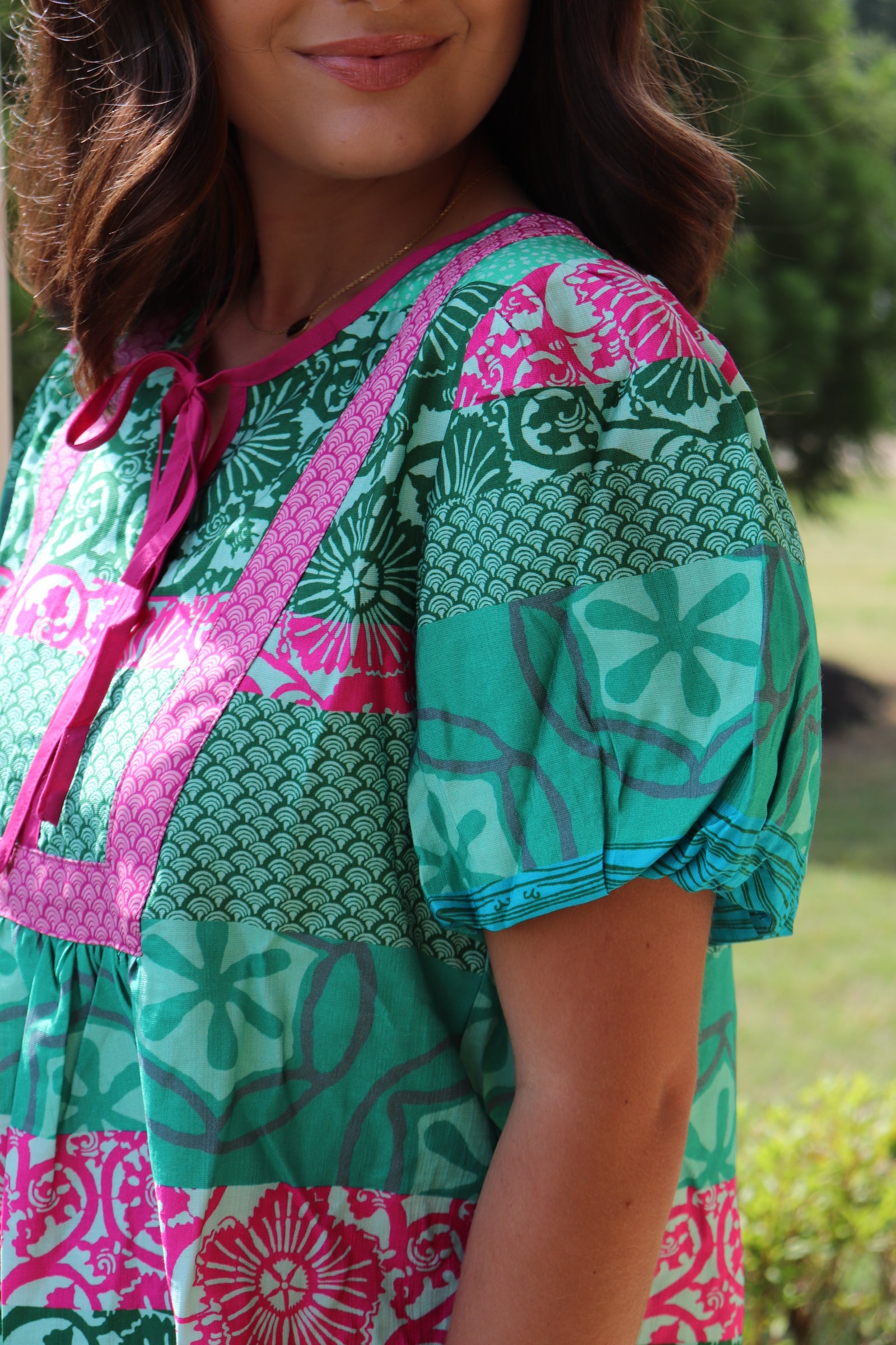 green and pink detailed design short sleeve blouse with pink front ties.  Loose fit and puff sleeves