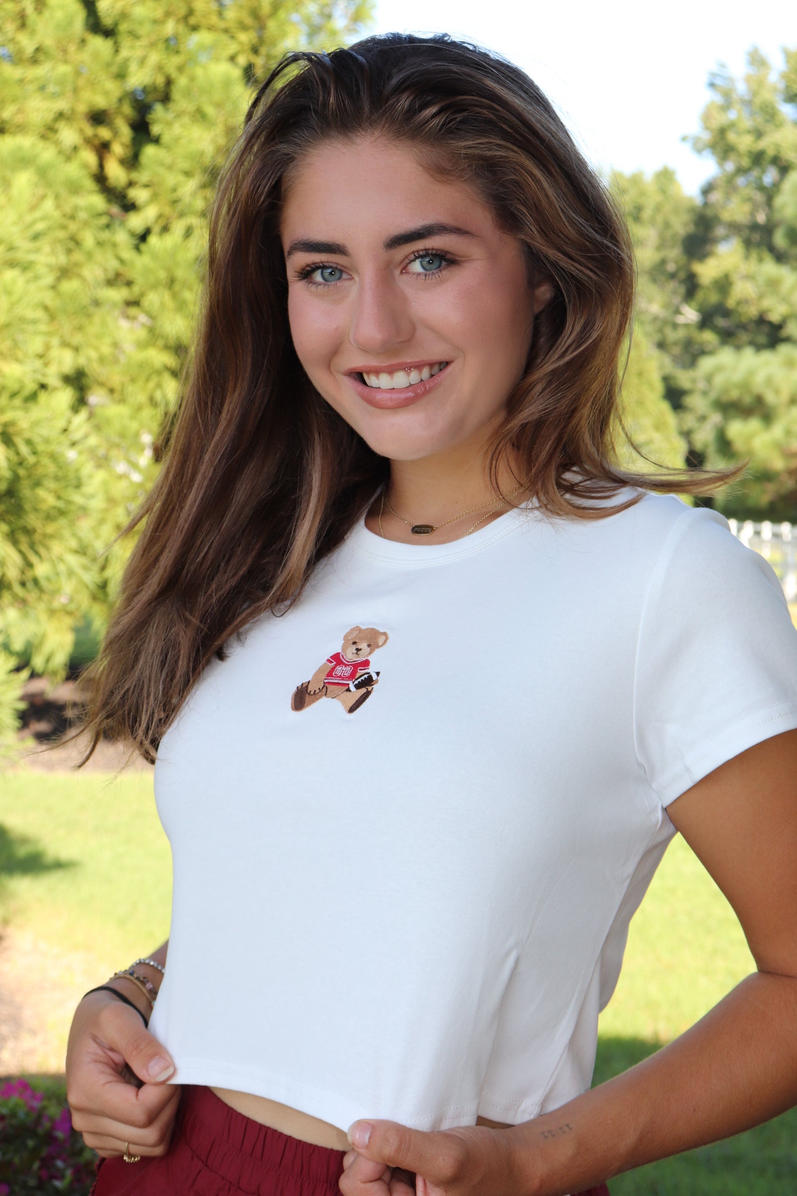 White baby tee with red football bear embroidery design