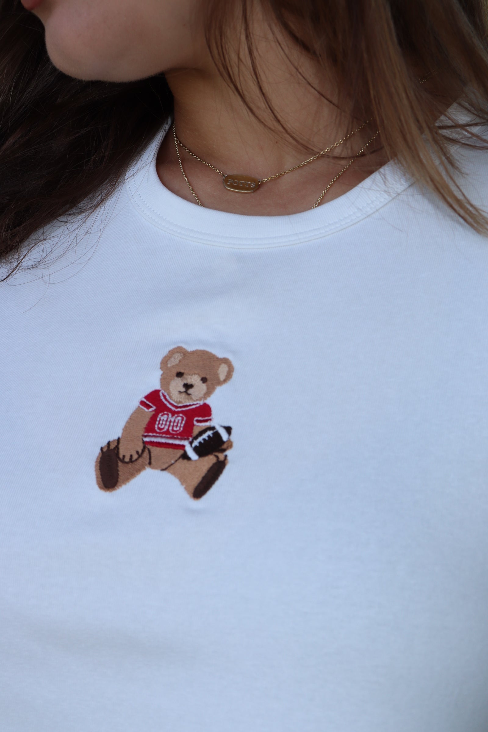 White baby tee with red football bear embroidery design