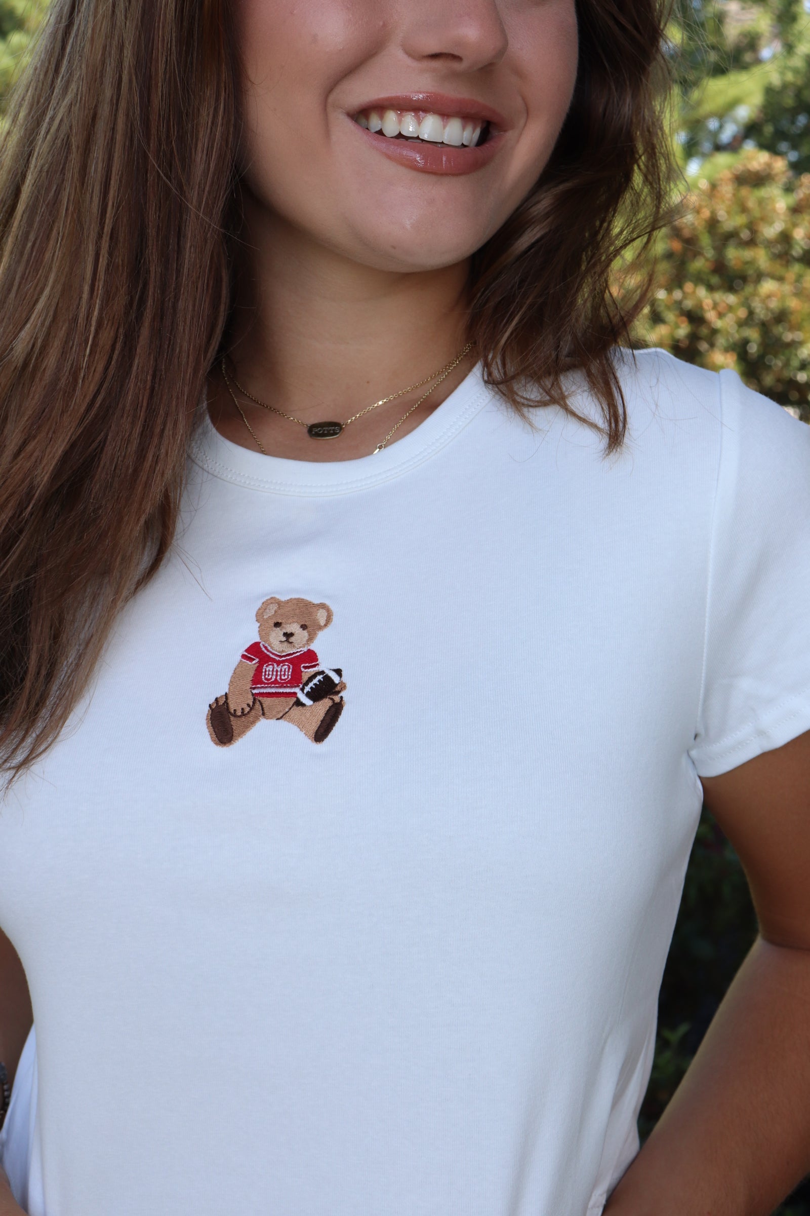 White baby tee with red football bear embroidery design
