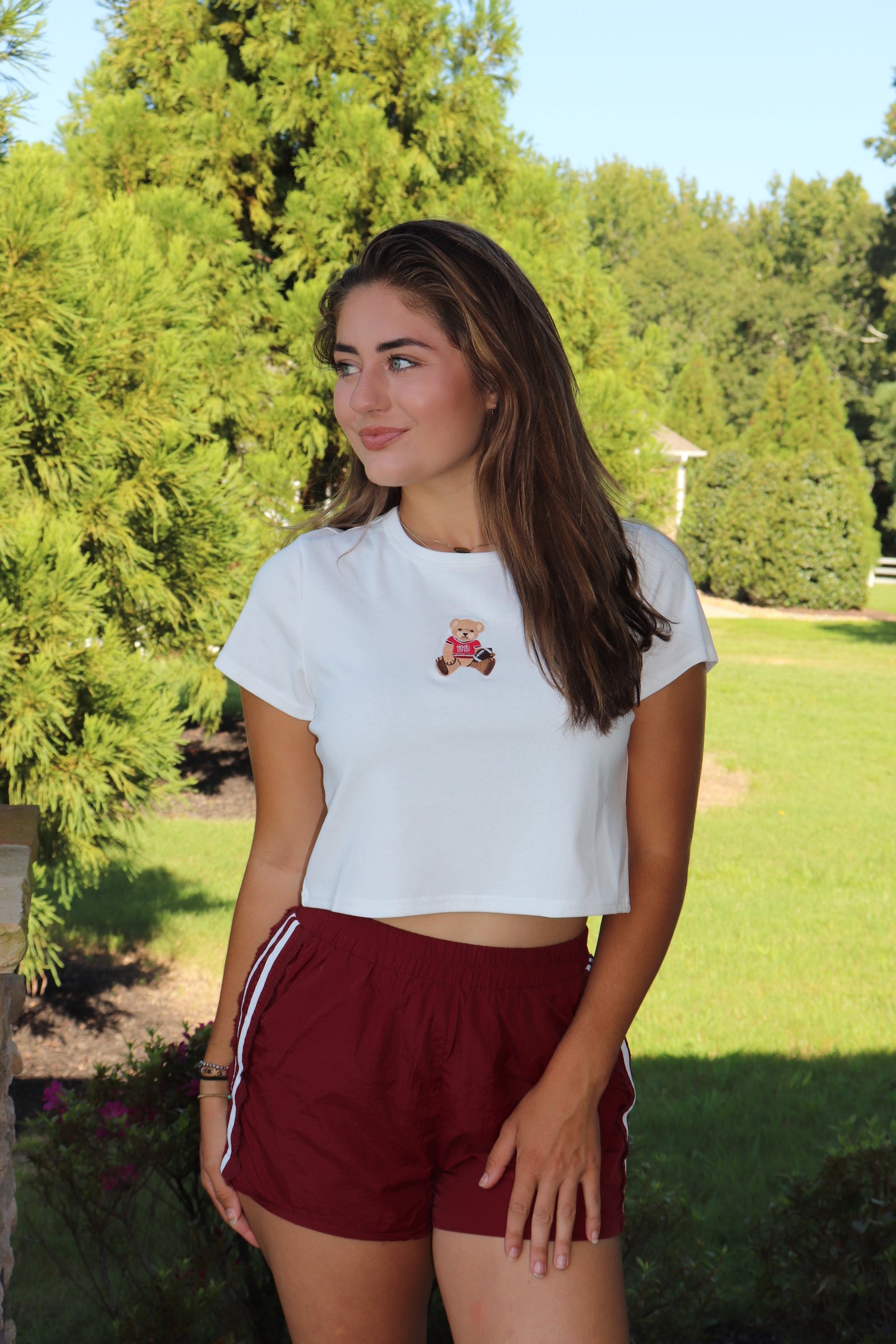 White baby tee with red football bear embroidery design