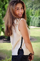 Cream sleeveless loose knit sweater with black stitching down the sides