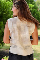 Cream sleeveless loose knit sweater with black stitching down the sides