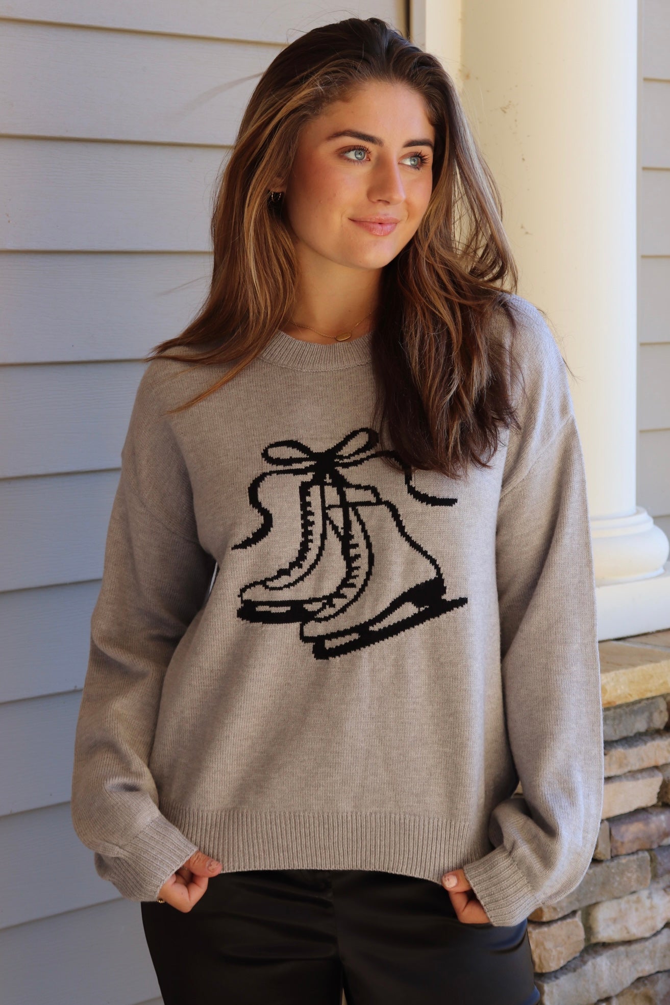 Gray sweater with black ice skate design