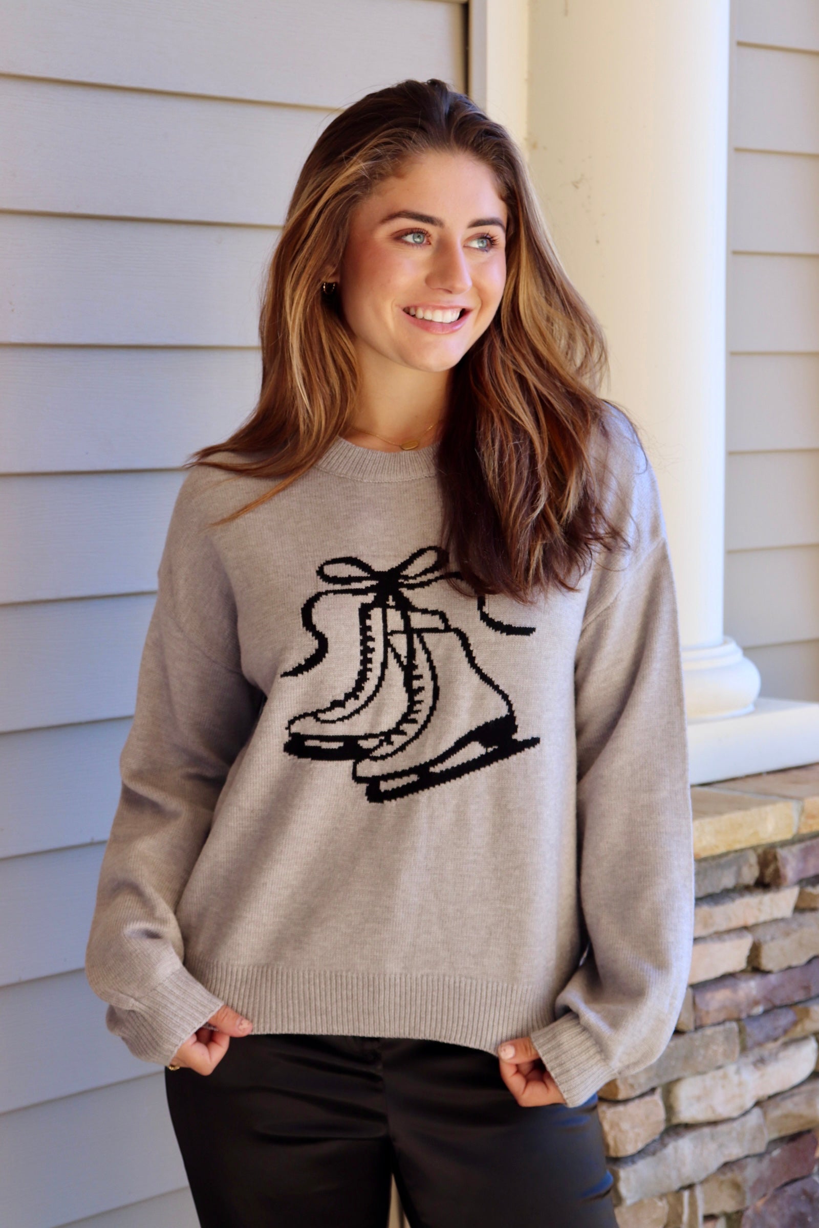 Gray sweater with black ice skate design