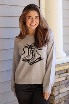 Gray sweater with black ice skate design