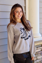 Gray sweater with black ice skate design