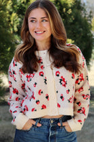 Cream cardigan with red & navy flowers features a delicate floral pattern