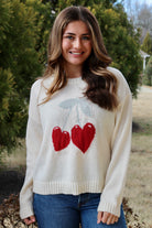 Cream long sleeve sweater with heart shaped red cherries
