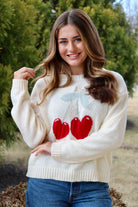 Cream long sleeve sweater with heart shaped red cherries
