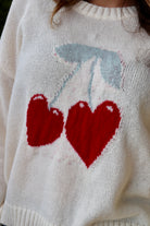 Cream long sleeve sweater with heart shaped red cherries