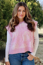 Pink short sleeve sweater vest with while floral print design