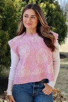 Pink short sleeve sweater vest with while floral print design