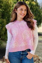 Pink short sleeve sweater vest with while floral print design