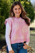 Pink short sleeve sweater vest with while floral print design