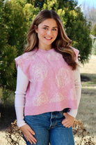 Pink short sleeve sweater vest with while floral print design