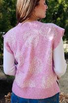 Pink short sleeve sweater vest with while floral print design