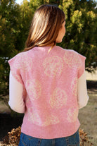 Pink short sleeve sweater vest with while floral print design