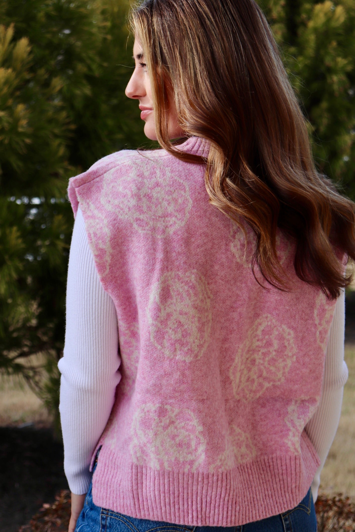 Pink short sleeve sweater vest with while floral print design