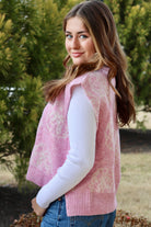 Pink short sleeve sweater vest with while floral print design