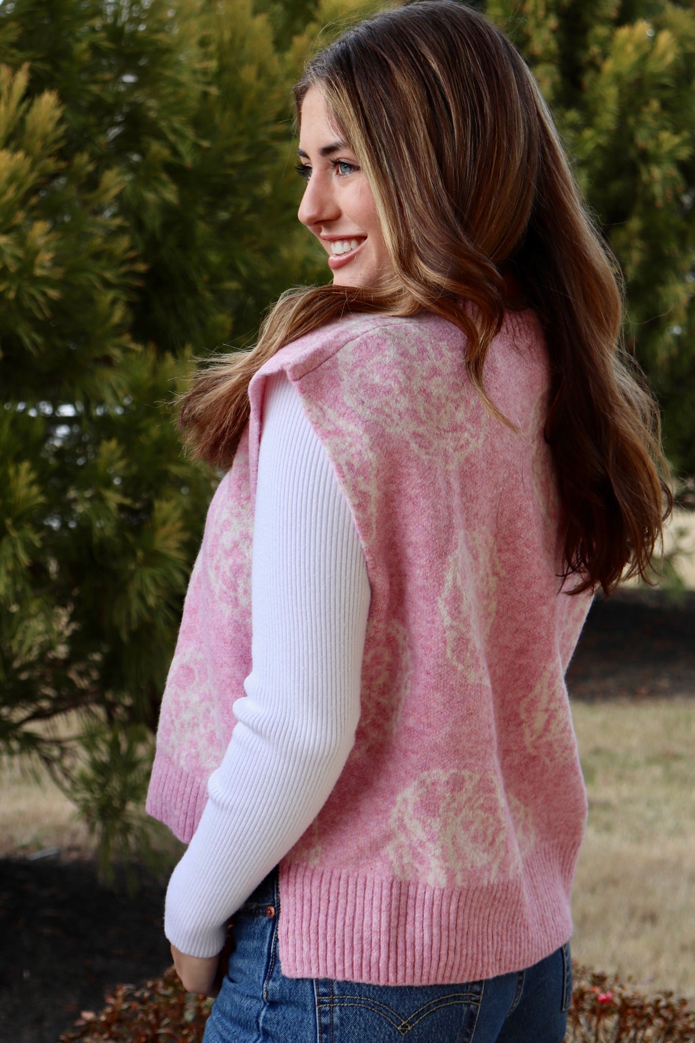 Pink short sleeve sweater vest with while floral print design
