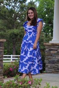 shades of blue floral midi dress. open back. elastic waist. flutter sleeves