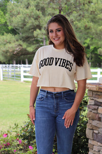 cream colored cropped tee with GOOD VIBES velvet writing