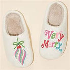 White slippers with colorful Very Merry wording and colorful ornament design. 