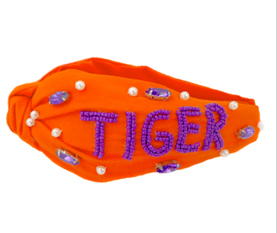 orange knotted headband with TIGER in purple seed beads.  Pearl & rhinestone accents