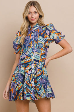 abstract print dress ruffled neckline. Mix of blues, greens & neutral colors